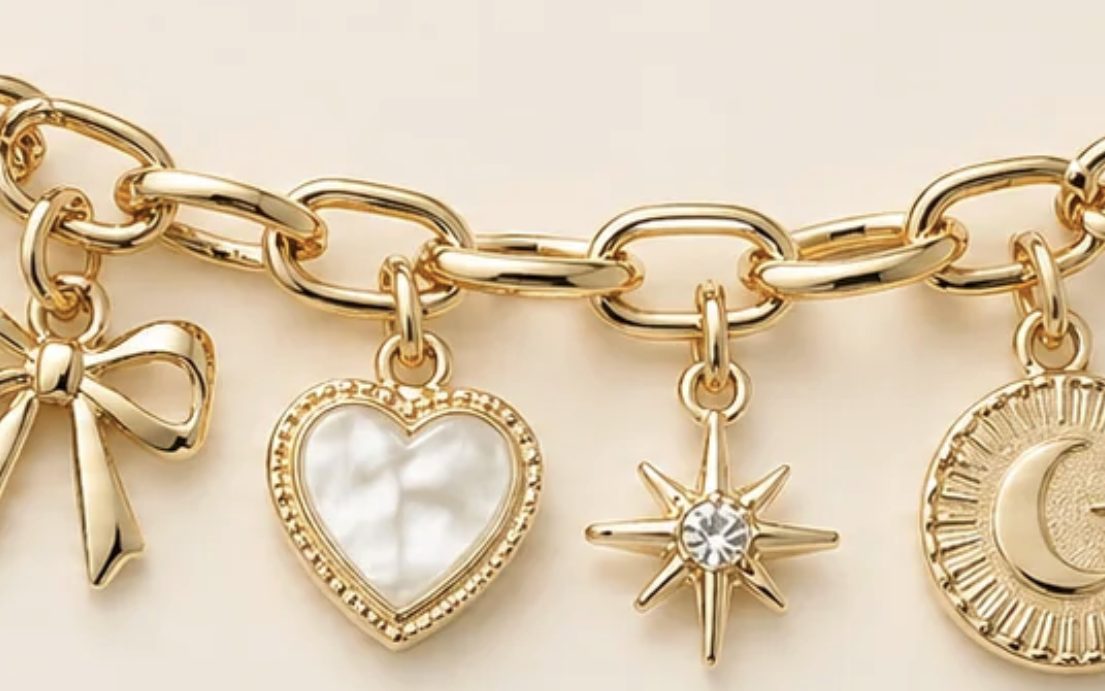 Gold link charm bracelet with bow, heart, star, and moon charms