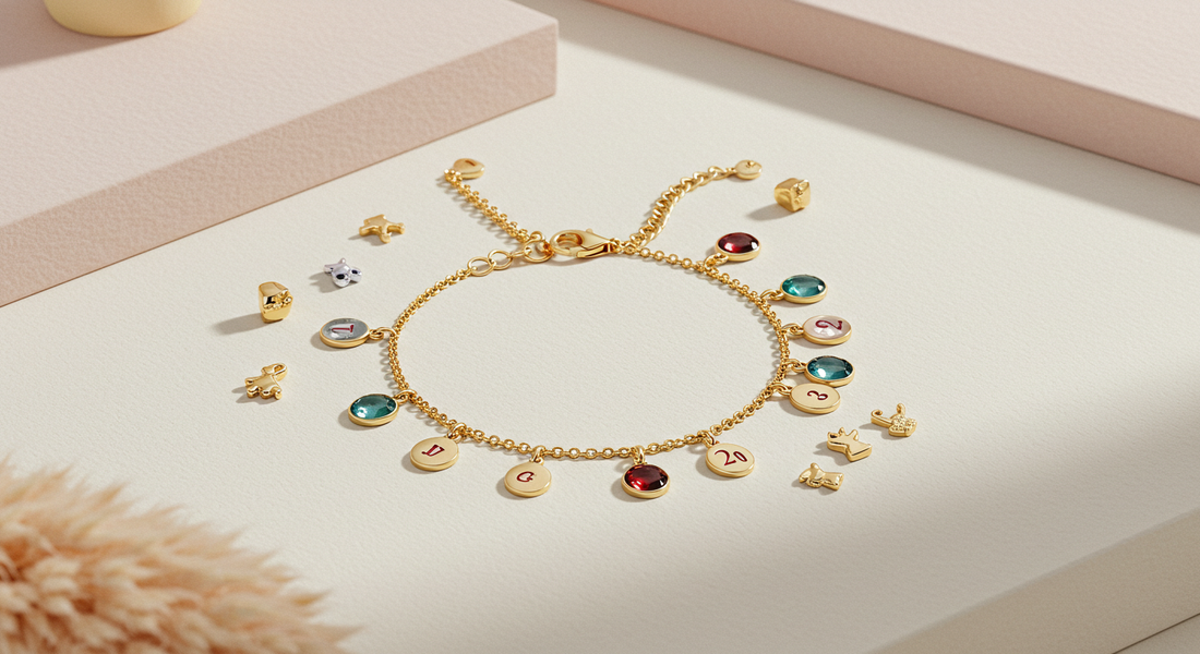 Minimalist gold chain bracelet with colorful birthstone and heart charms on neutral background