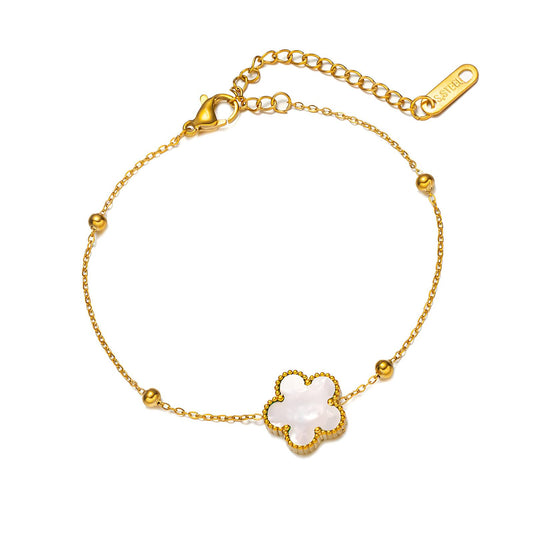 Pulsera de flores de acero inoxidable bañada en oro de 18 quilates.