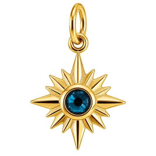 Gold-tone compass starburst charm with deep blue crystal center