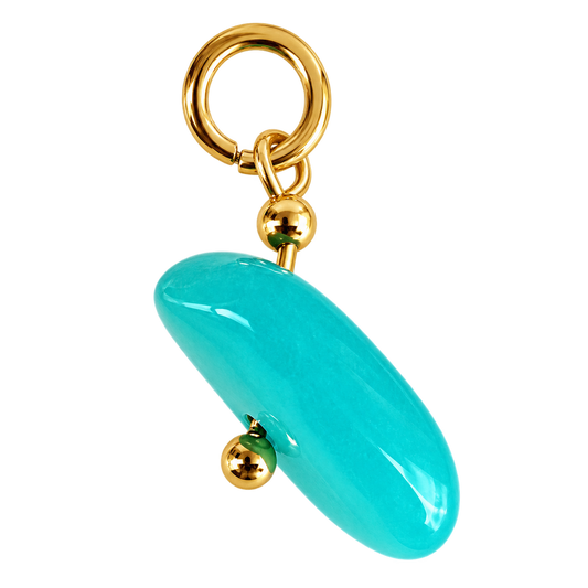 Smooth turquoise rock charm with polished gold-tone accents