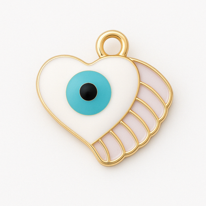 White heart-shaped enamel charm with a turquoise eye and soft pink wing detail, outlined in gold and centered on a clean white background.